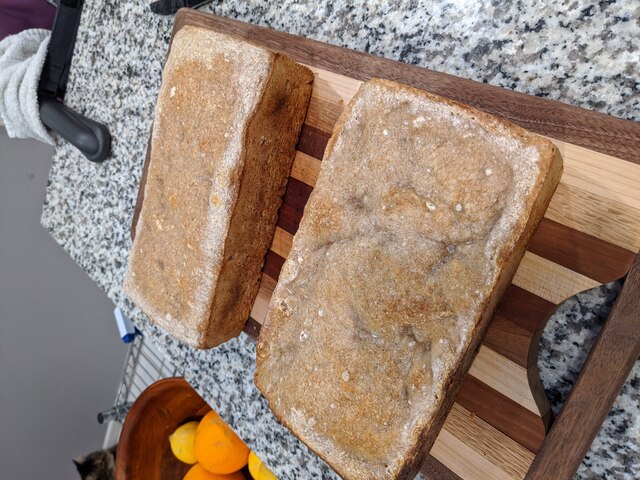 Two loaves of bread on a cutting board