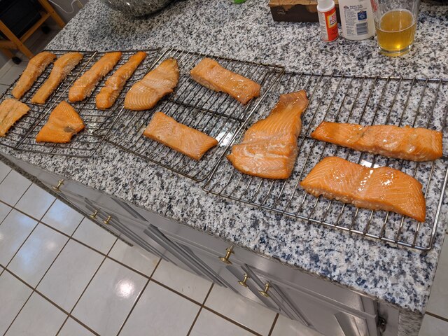 Completed, smoked salmon, still a pink color similar to before it went on, but slightly darker and with some browned edges.  More shiny than previously, due to the maple syrup I mop on.